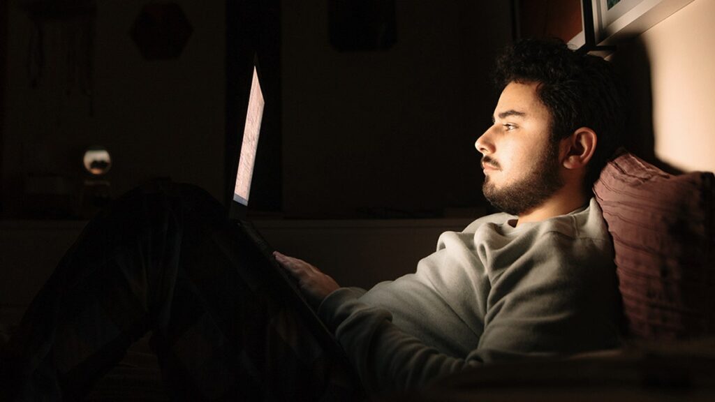 Man laptop bed.jpg
